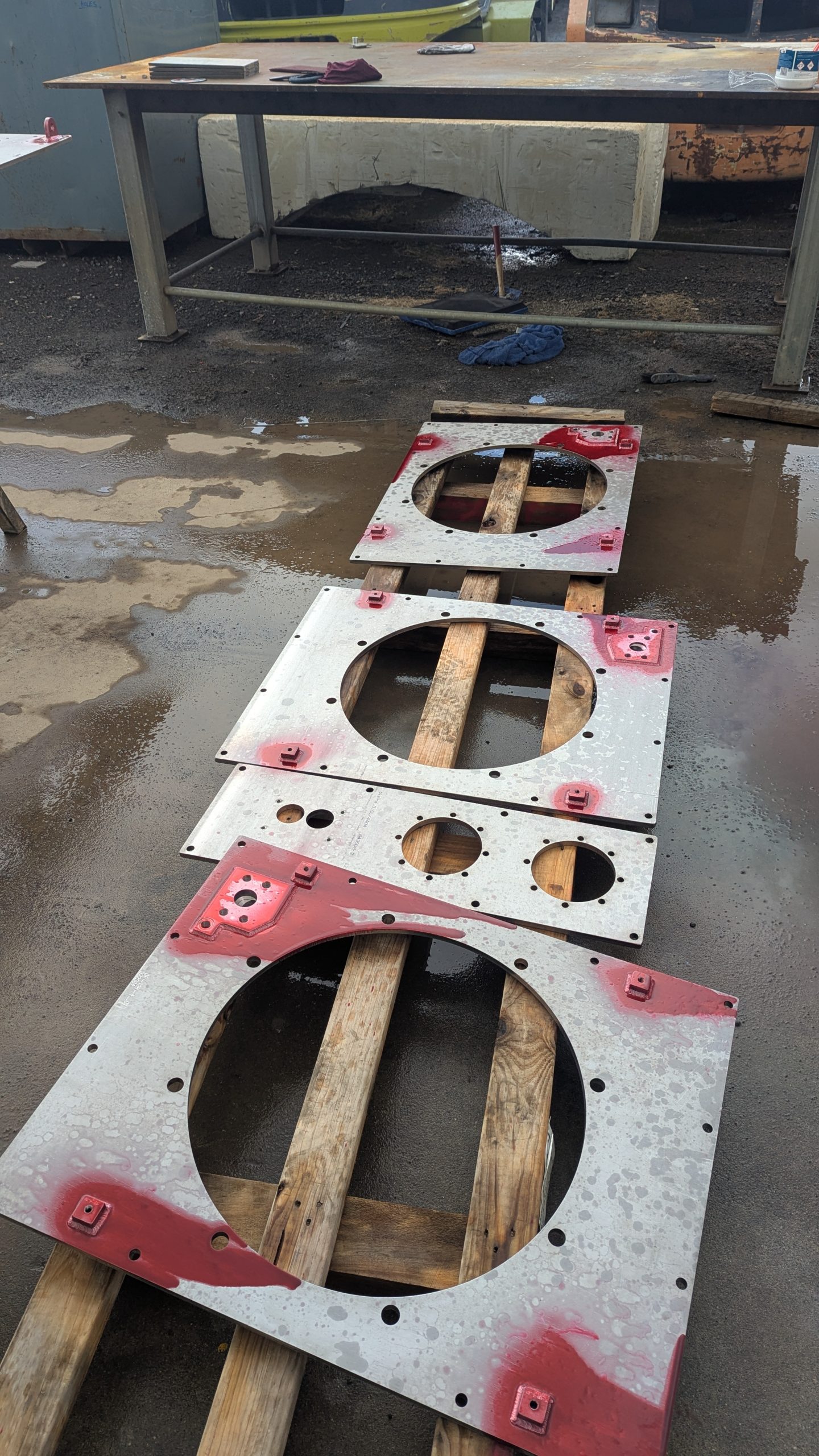 Stainless steel tank components laid out for inspection and testing during fabrication.